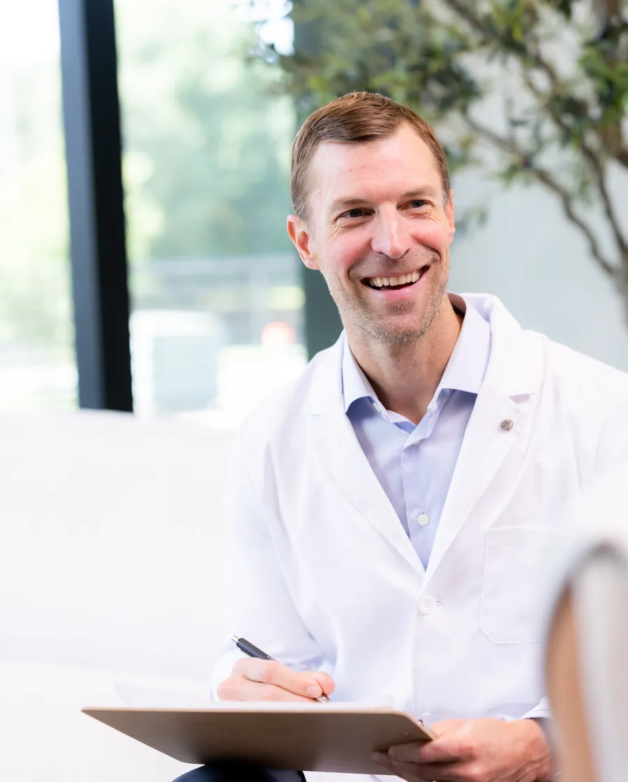 Dr. Josh Axe talking with a patient at The Longevity Club + Clinic in Franklin, TN